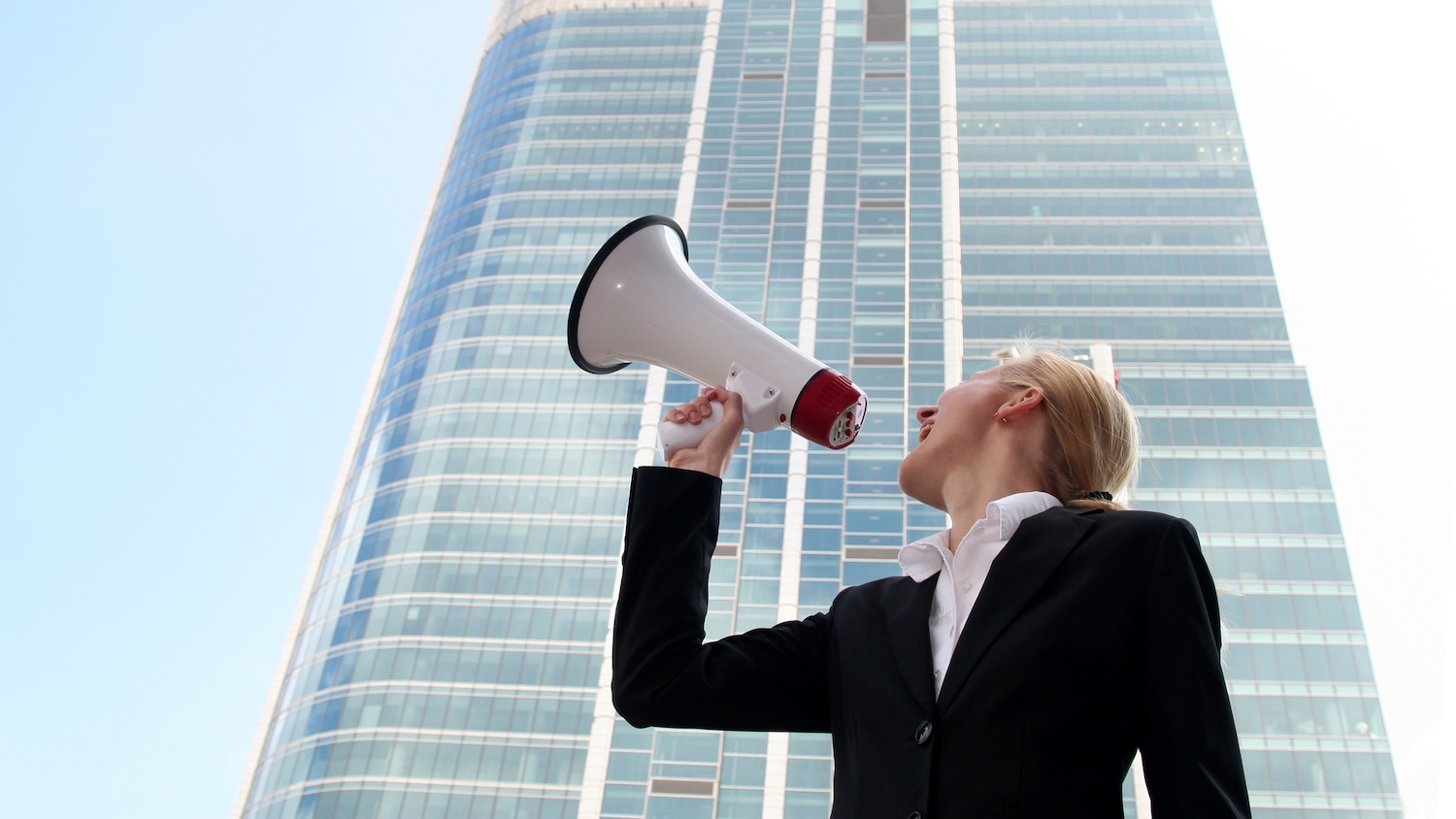 Image of a woman shouting outside an office block for UK BIM Framework clients story