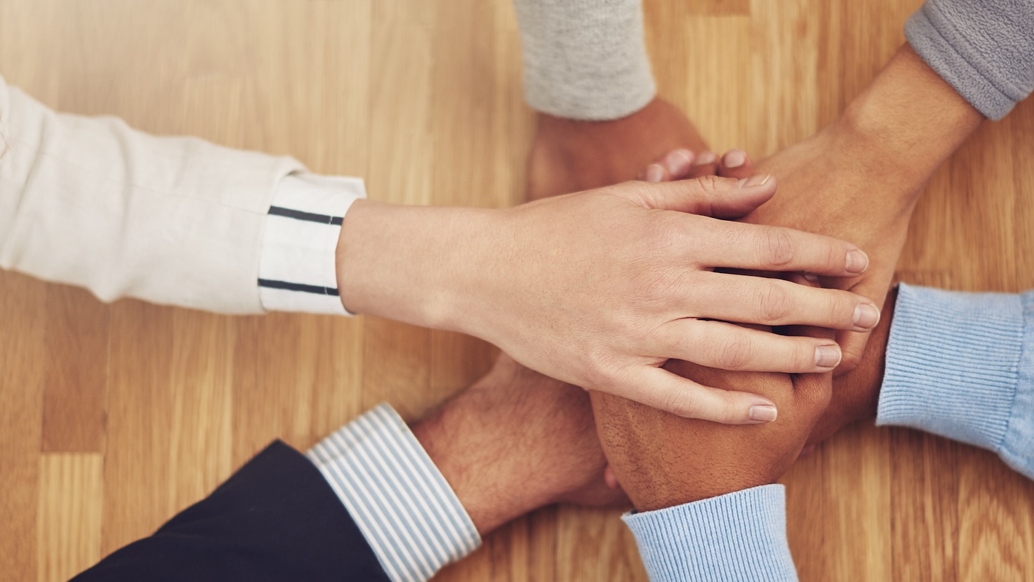 Image of hands stacked upon each other for trust in construction opinion