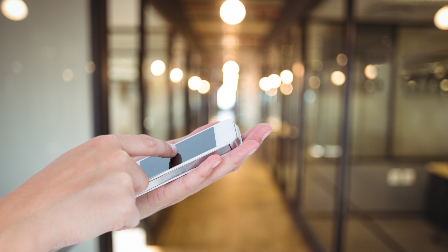 Smart buildings image - someone using a smart phone to book a meeting room