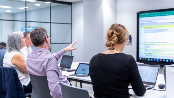 Image of people training in an office for Skanska data academy story